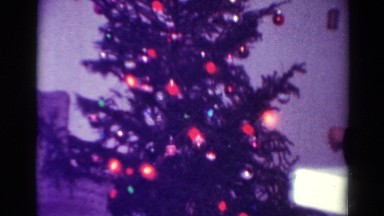 1954: the young man sets up the tree of holiday glee for the family OHIO