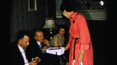 1956: a woman distributes snacks between several people sitting NEW YORK