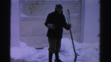 1956: a man shovels snow outdoor. NEW YORK