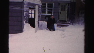 1956: two people shoveling knee-deep snow outdoor of a house NEW YORK