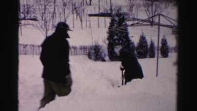 1956: man sneaks up on woman shoveling snow in yard NEW YORK