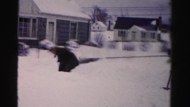 1956: shoveling deep snow outdoor a house NEW YORK