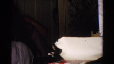 1954: family members talking in front of christmas tree with lights NEW YORK
