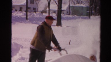 1954: a man using a snowblower to clear a path through the snow NEW YORK