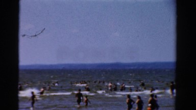 1954: people in the water at the beach NEW YORK