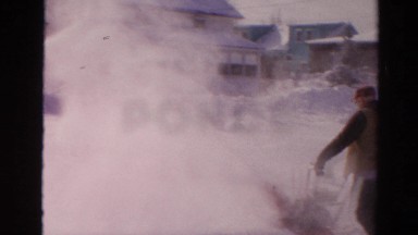 1954: a man using a snowblower to clear a path through the snow NEW YORK