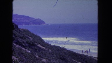1962: the view of a beach with a woman running in the water SAN PEDRO
