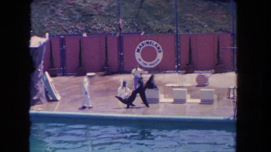1962: black seals are being trained by a man in white dress SAN PEDRO