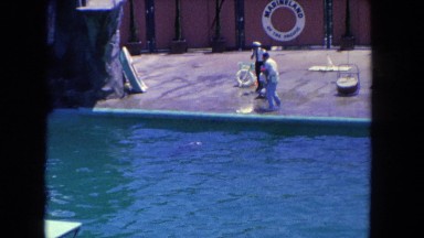 1962: three men on deck overlooking a large pool with dolphins SAN PEDRO