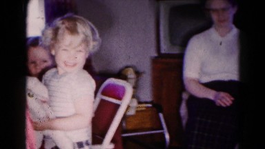 1959: children smile and walk around as three adult women in fifties attire