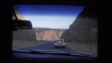1962: cars drive along mountain road SAN PEDRO, CALIFORNIA