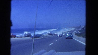 1962: view of landscape and vehicles on the road from a moving car SAN PEDRO