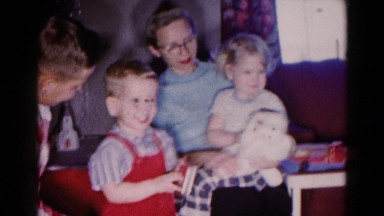 1959: A Family Gathers Around the Couch Smiling Together in Hagerstown