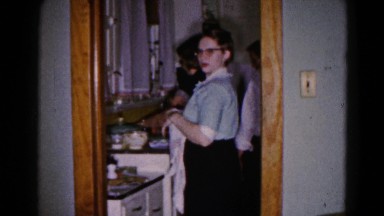 1959: a lady standing in the kitchen closes the door of cupboard HAGERSTOWN