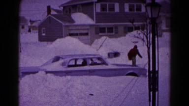 1959: three men are trying to get a car unstuck from a snow drift one man falls