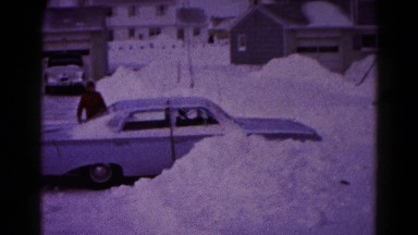 1959: man plows his way through a rigorous snow storm in his car. HAGERSTOWN