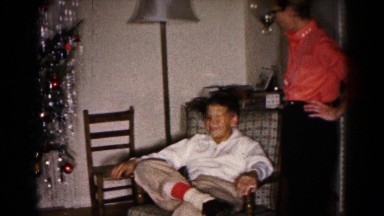 1959: two young men discuss the christmas tree one is seated