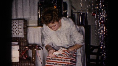 1959: a young woman gingerly opens a package