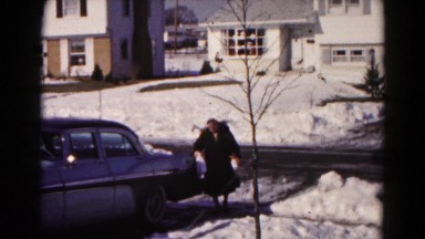 1959: woman walking from car carrying bags on slippery concrete HAGERSTOWN