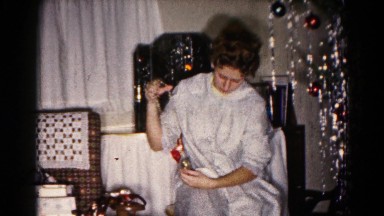 1959: a young woman in a nightgown seated next to a christmas tree HAGERSTOWN