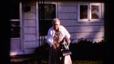 1962: Elderly Woman Preparing to Take Her Grandson Out for the Day Catskill
