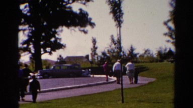 1962: everybody hustles toward the afternoon church event in the park CATSKILL