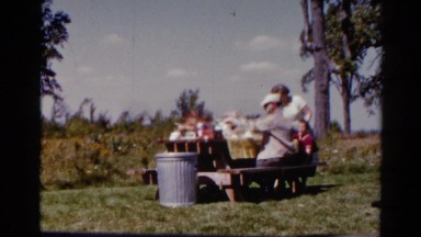 1962: a family is eating outdoors in the summer CATSKILL, NEW YORK