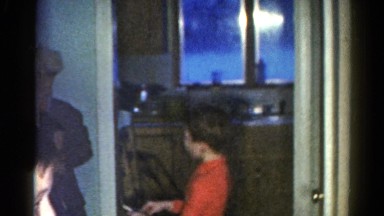 1962: boys talking walking in front of kitchen door orange shirt winter hat