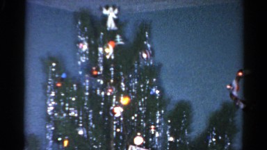 1962: a group of young posing in front of a christmas tree with many decorations