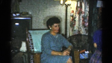 1962: a family sharing and talking on christmas while opening their presents