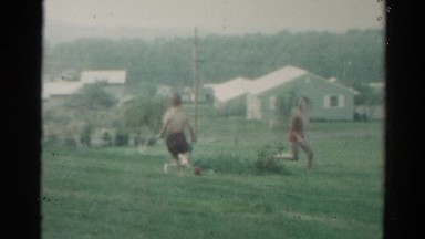 1962: kids are running in the rain and playing CATSKILL, NEW YORK