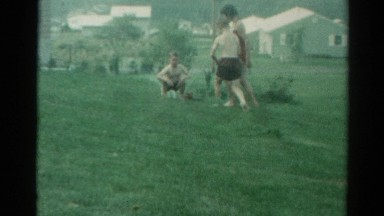 1962: brothers and sister playing and having fun with water in the backyard