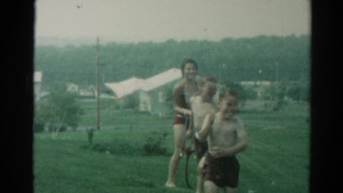 1962: water sprinkle woman children run CATSKILL, NEW YORK
