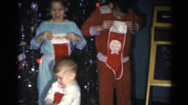 1962: kids are checking their christmas socks CATSKILL, NEW YORK