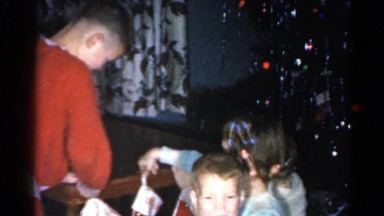 1962: children in pajamas hanging their christmas stockings