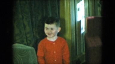 1951: a happy little boy is smiling and talking and posing for the camera