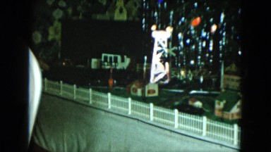 1951: a miniature train moving on a track under a christmas tree CLEVELAND, OHIO