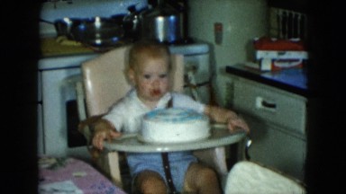 1951: baby playing with cake on the table CLEVELAND, OHIO