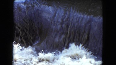 1951: a view of a waterfall splashing with white water and foam