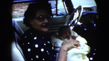 1951: mother is holding a newborn baby wrapped in a blanket