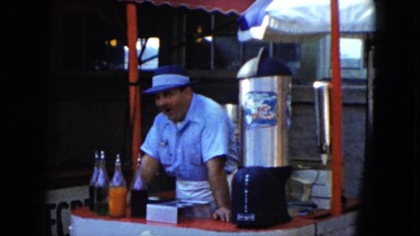 1951: several shops hawking food and drinks waiting for customers at a fair