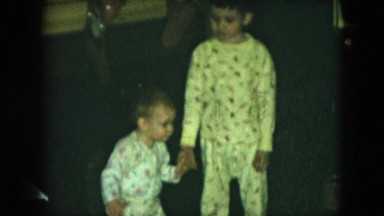 1951: children play indoor love siblings dressed toddler holding CLEVELAND, OHIO
