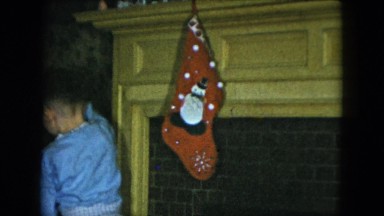 1951: young male child in pajamas putting up stockings CLEVELAND, OHIO