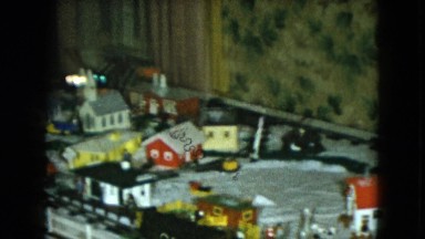 1951: a boy plays with a tabletop train set that includes a mock town CLEVELAND
