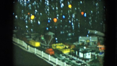 1951: christmas tree with a model village and a model train circling around it
