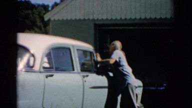 1957: man cleaning his car CATSKILL, NEW YORK