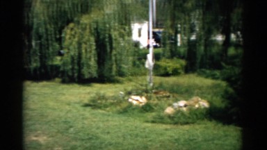1957: a young woman sunbathing sitting in a extendible chair in a courtyard