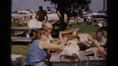 1957: various people gathered around a picnic table eating lunch CATSKILL