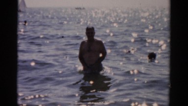 1957: a man is enjoying a day at the beach. CATSKILL, NEW YORK