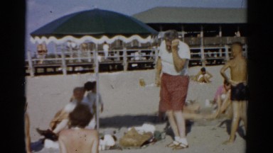 1957: hands on hips at the beach CATSKILL, NEW YORK